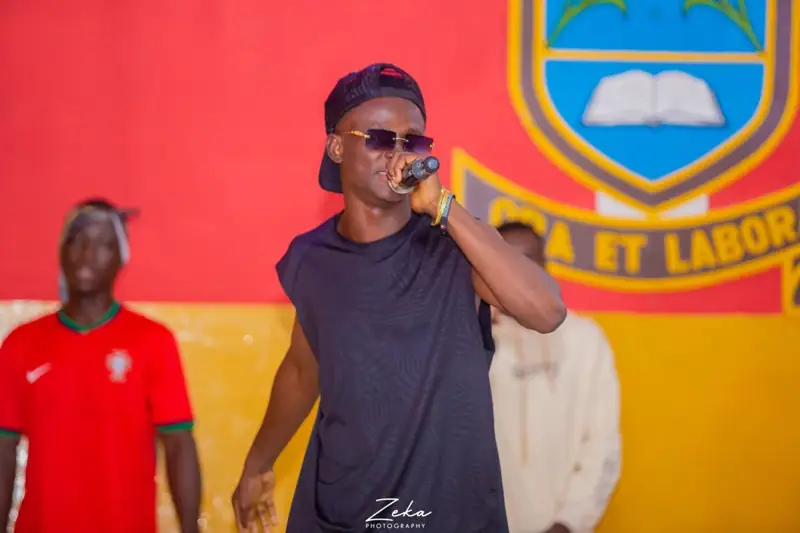 Wiz Jupita performing on stage with a microphone